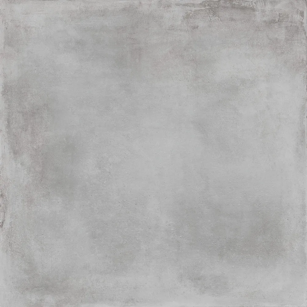 Gresová dlaždica Caementum Griseo v rozmere 61 × 61 cm so zvýšeným protišmykom R11, fotená kolmo zhora. Sivý matný povrch s oblačnou kresbou pripomína liaty betón.